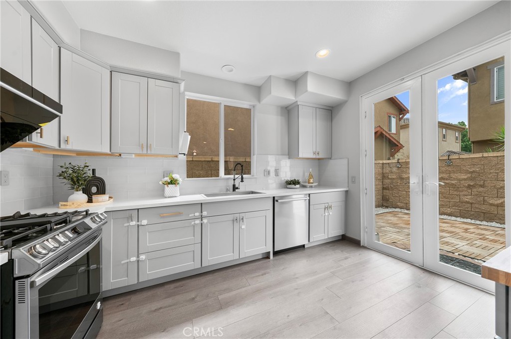 311 Nimbus Tustin, CA 92782 - Photo 13 of 39 a kitchen with white cabinets and white appliances