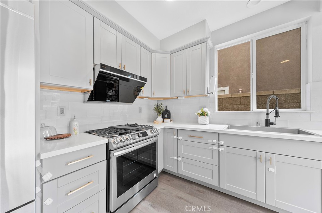 311 Nimbus Tustin, CA 92782 - Photo 14 of 39 a kitchen with cabinets appliances and a sink