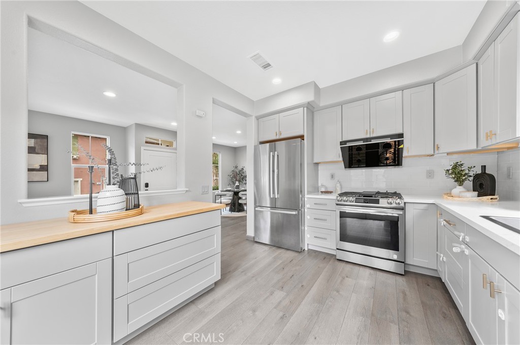 311 Nimbus Tustin, CA 92782 - Photo 16 of 39 a large kitchen with a sink dishwasher stove and refrigerator