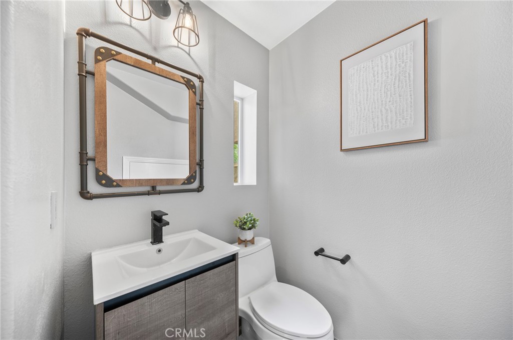 311 Nimbus Tustin, CA 92782 - Photo 22 of 39 a bathroom with a toilet a sink and mirror
