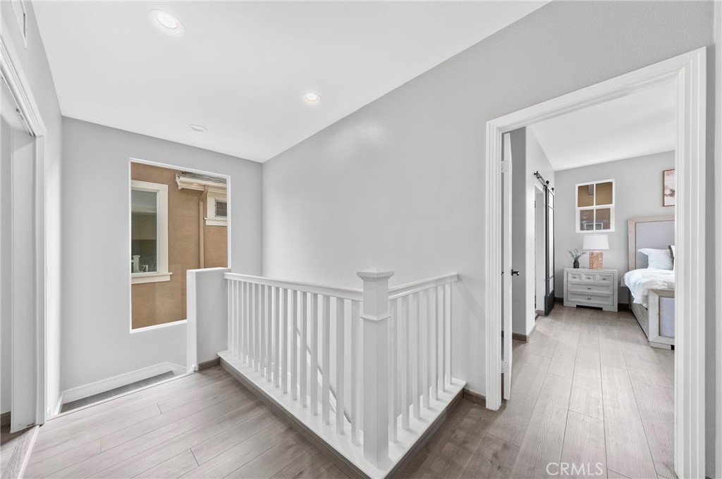 311 Nimbus Tustin, CA 92782 - Photo 23 of 39 a view of a hallway with wooden floor and a livingroom