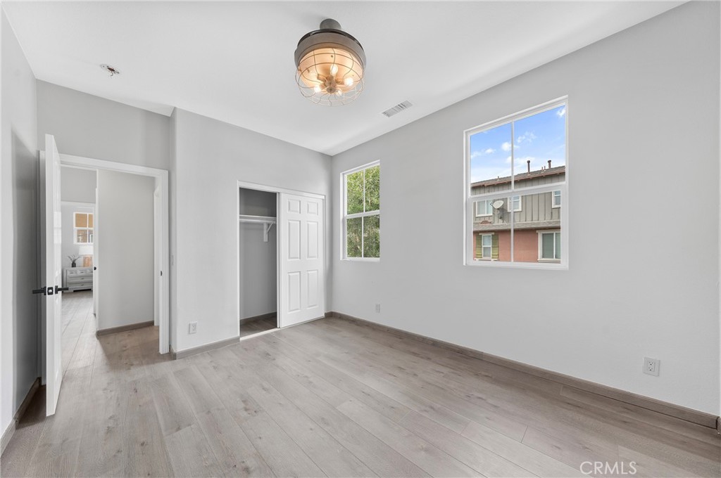 311 Nimbus Tustin, CA 92782 - Photo 27 of 39 an empty room with wooden floor and windows