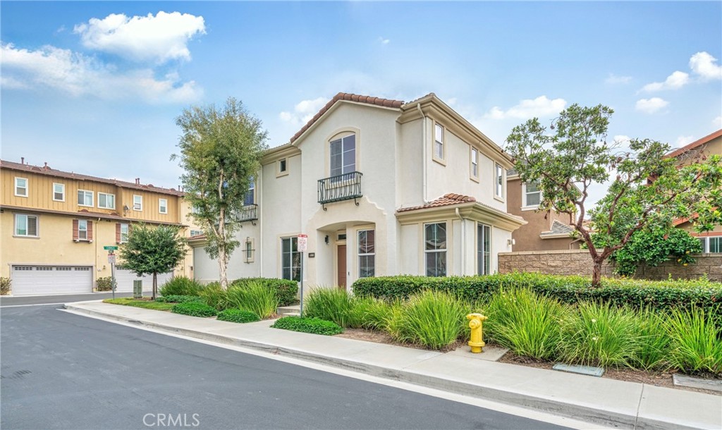 311 Nimbus Tustin, CA 92782 - Photo 3 of 39 a view of a white house with a large windows and plants and large trees