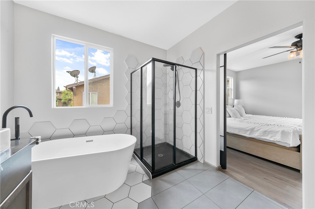 311 Nimbus Tustin, CA 92782 - Photo 34 of 39 a en suite bathroom with a double vanity sink a mirror and a bathtub
