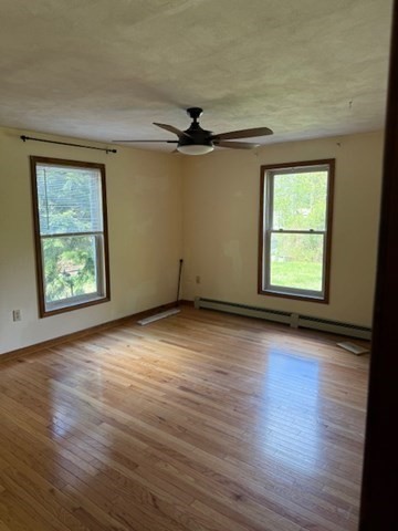 30 Groton Road Shirley, MA 01464 - Photo 10 of 25 an empty room with wooden floor chandelier fan and windows