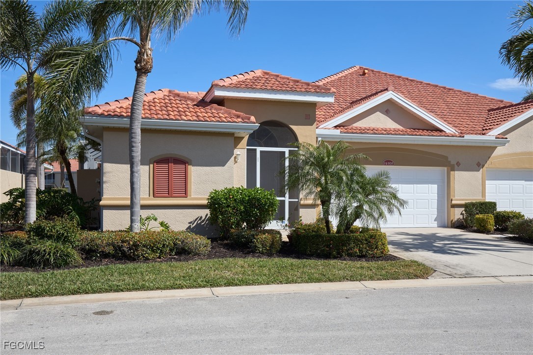 14101 Bently Circle Fort Myers, FL 33912 - Photo 1 of 29 a front view of a house with a garden