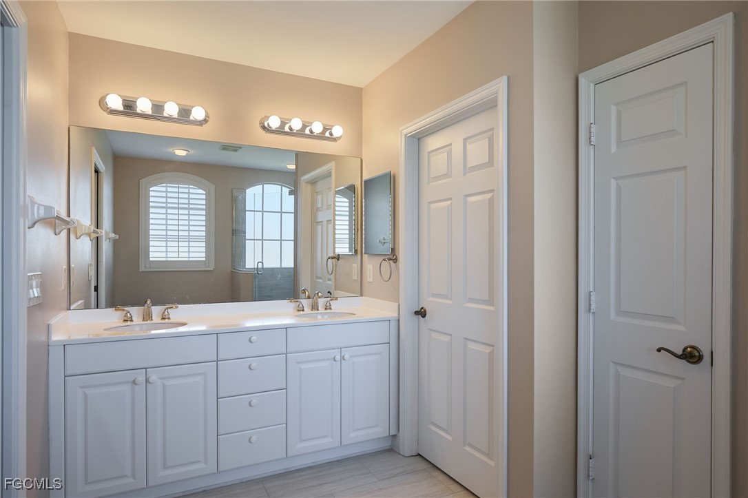 14101 Bently Circle Fort Myers, FL 33912 - Photo 15 of 29 a spacious bathroom with a double vanity sink mirror and