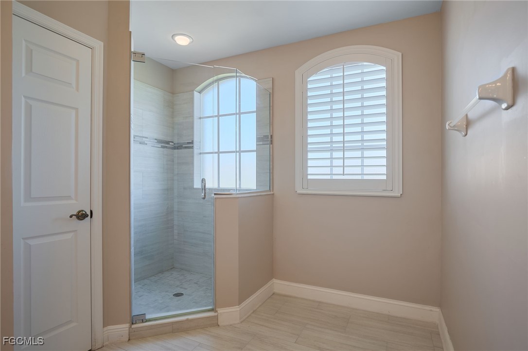 14101 Bently Circle Fort Myers, FL 33912 - Photo 16 of 29 a bathroom with a window and a shower