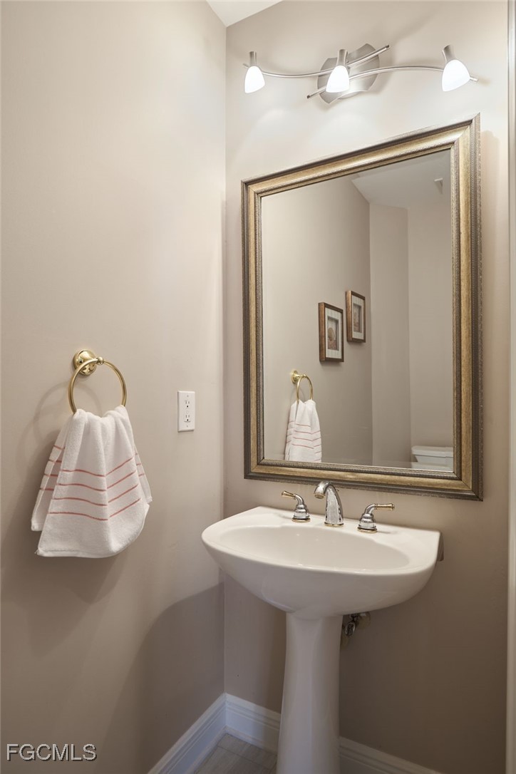 14101 Bently Circle Fort Myers, FL 33912 - Photo 17 of 29 a bathroom with a sink and mirror