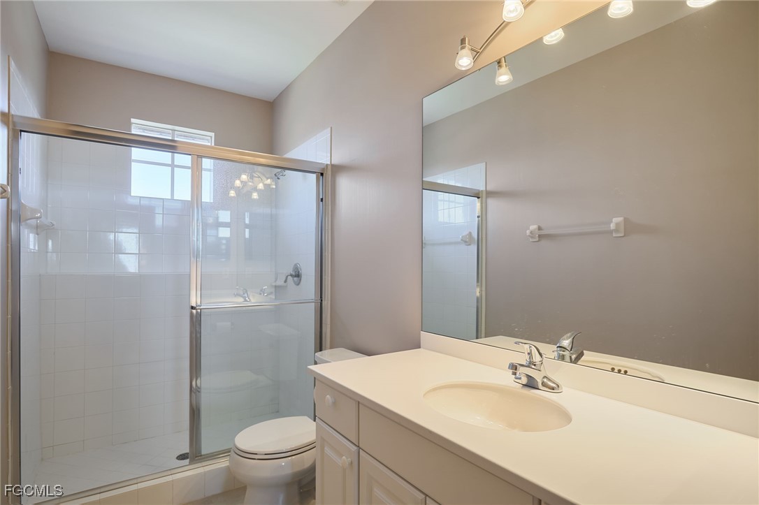 14101 Bently Circle Fort Myers, FL 33912 - Photo 20 of 29 a bathroom with a sink a toilet and shower