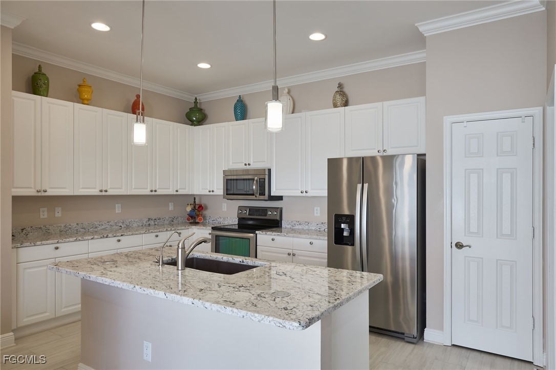 14101 Bently Circle Fort Myers, FL 33912 - Photo 2 of 29 a kitchen with stainless steel appliances granite countertop a refrigerator a sink and a stove