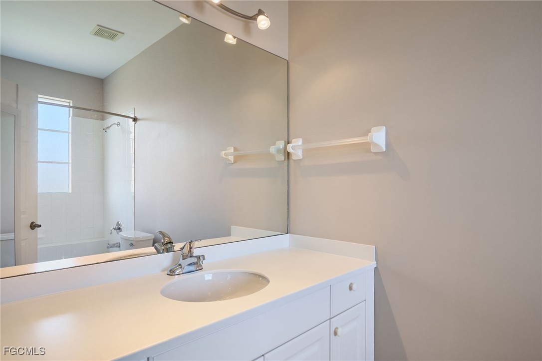 14101 Bently Circle Fort Myers, FL 33912 - Photo 21 of 29 a bathroom with a sink and a mirror