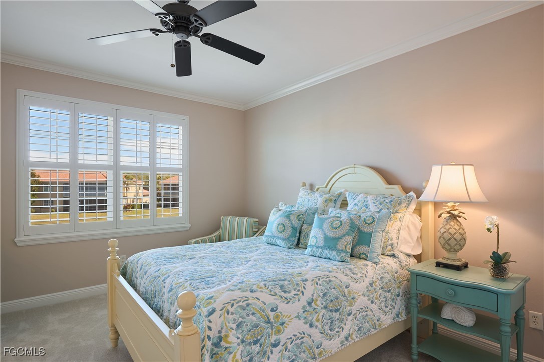 14101 Bently Circle Fort Myers, FL 33912 - Photo 22 of 29 a bedroom with a bed and a chandelier