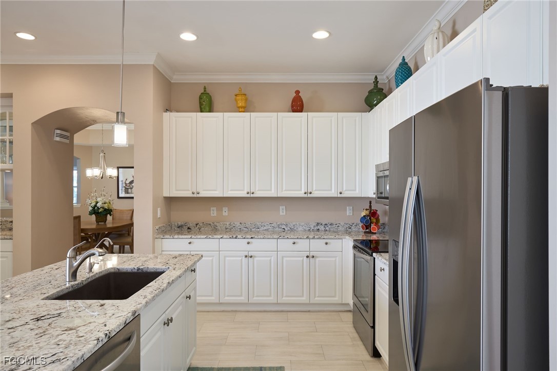 14101 Bently Circle Fort Myers, FL 33912 - Photo 3 of 29 a kitchen with stainless steel appliances granite countertop a refrigerator sink and cabinets