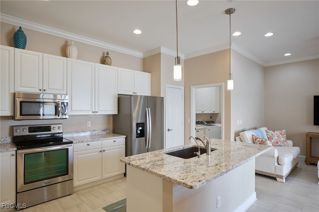 14101 Bently Circle Fort Myers, FL 33912 - Photo 4 of 29 a kitchen with kitchen island a sink stainless steel appliances and cabinets