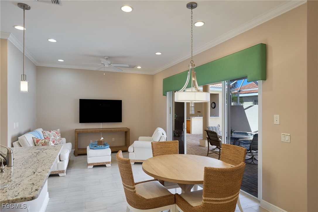 14101 Bently Circle Fort Myers, FL 33912 - Photo 5 of 29 a living room with furniture a flat screen tv and kitchen view