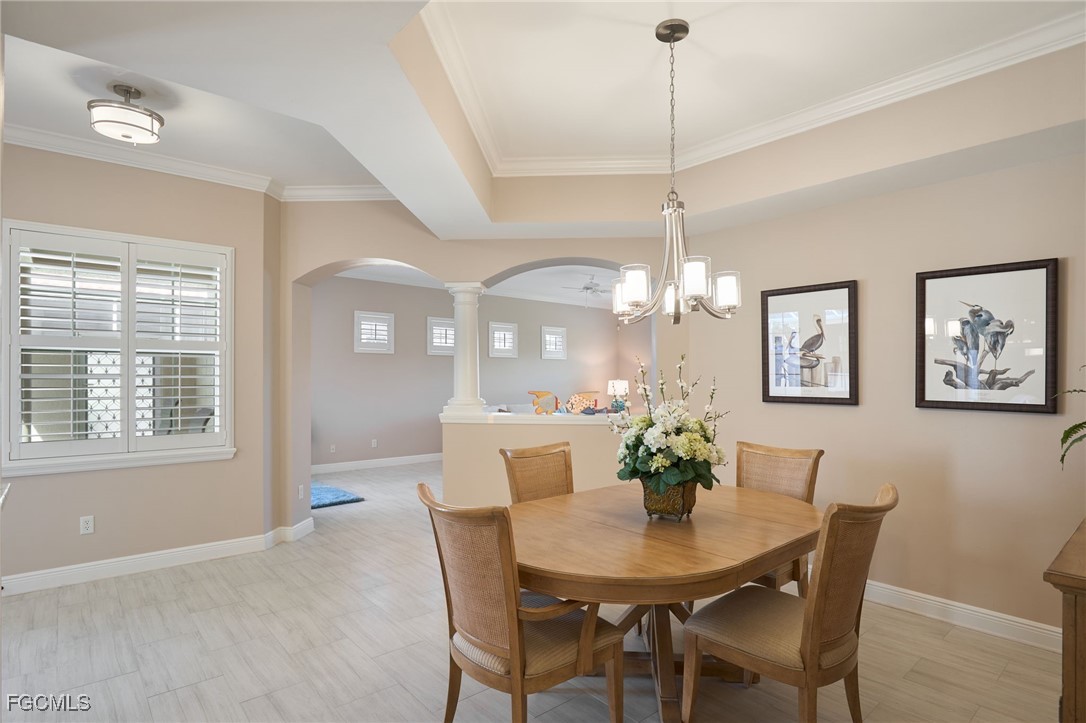 14101 Bently Circle Fort Myers, FL 33912 - Photo 8 of 29 a dining room with furniture a chandelier and window