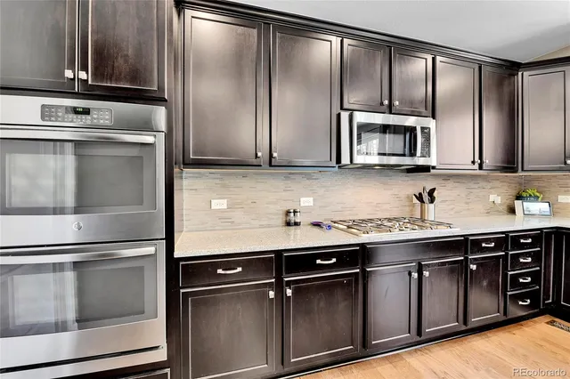 a kitchen with granite countertop stainless steel appliances and cabinets