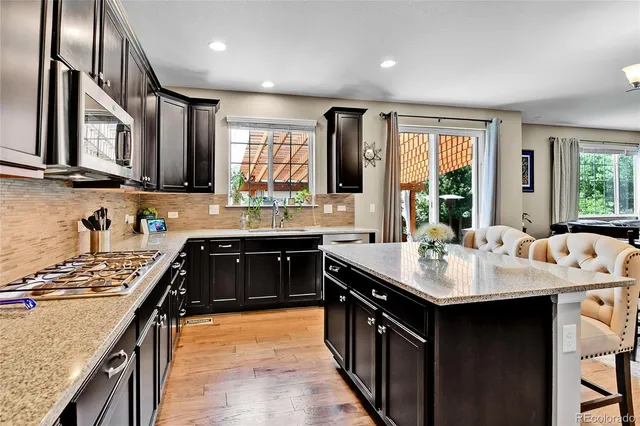a kitchen with a stove a sink and a refrigerator