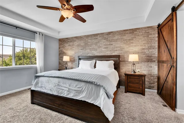 a bedroom with a bed and a flat tv screen