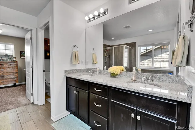 a bathroom with a granite countertop sink a large mirror and a