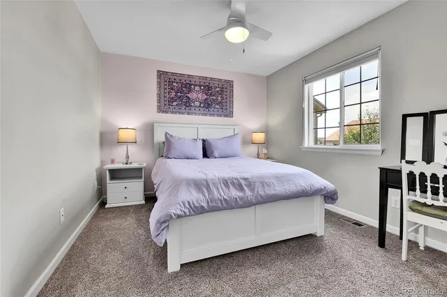 a spacious bedroom with a bed and a table