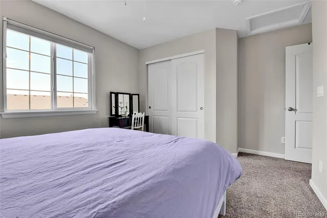 a spacious bedroom with a bed and a dresser