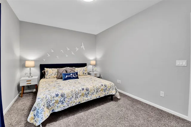 a bedroom with a bed and a lamp