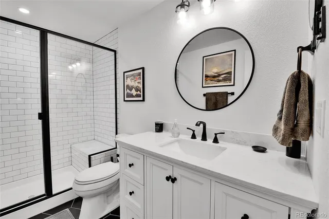 a bathroom with a toilet a sink and a mirror