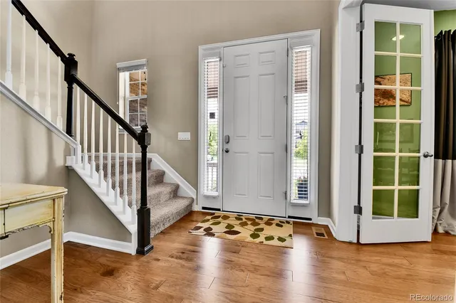 a view of an entryway with wooden floor and door