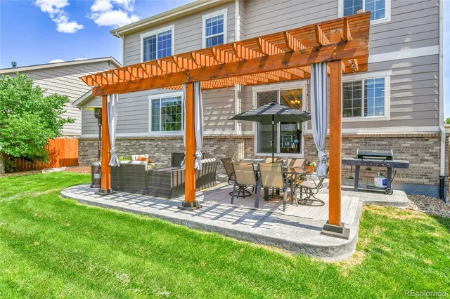 a view of a house with backyard porch and sitting area