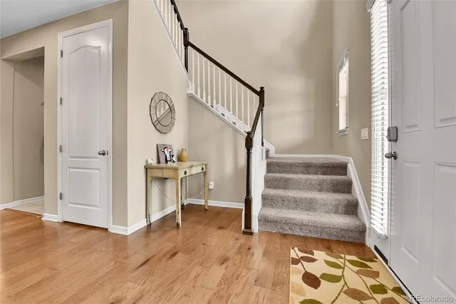 a view of a hallway view with wooden floor and staircase