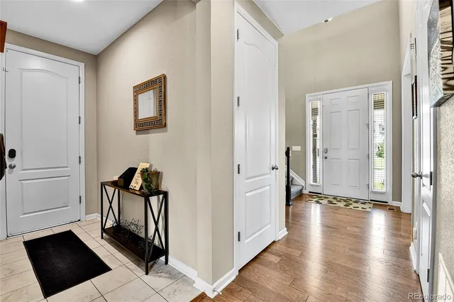 a view of a hallway with wooden floor and closet