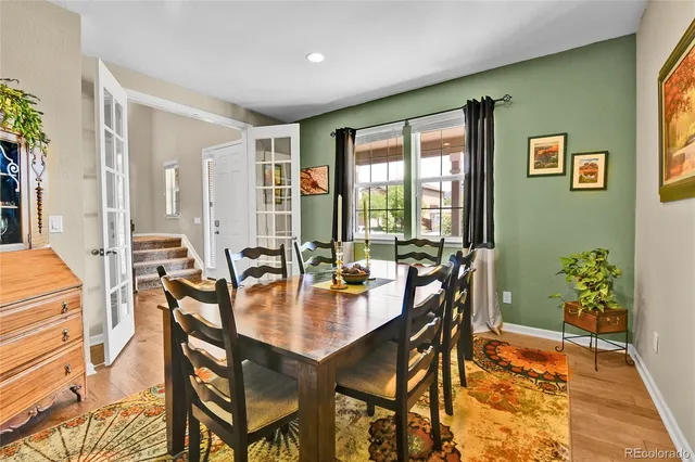 a dining room with a table and chairs