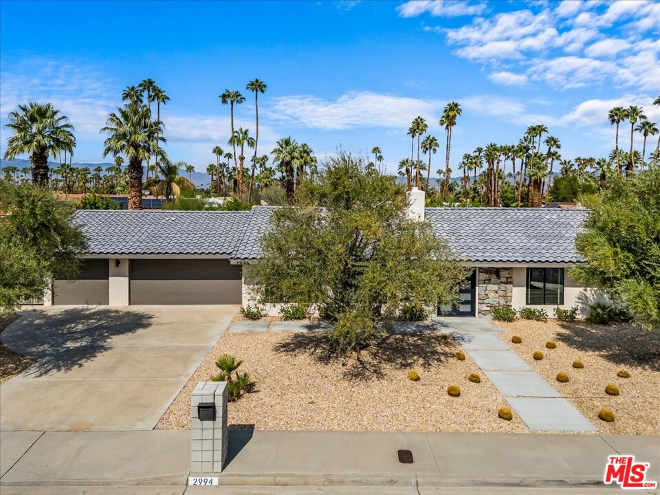 a view of a house with a yard and tree s