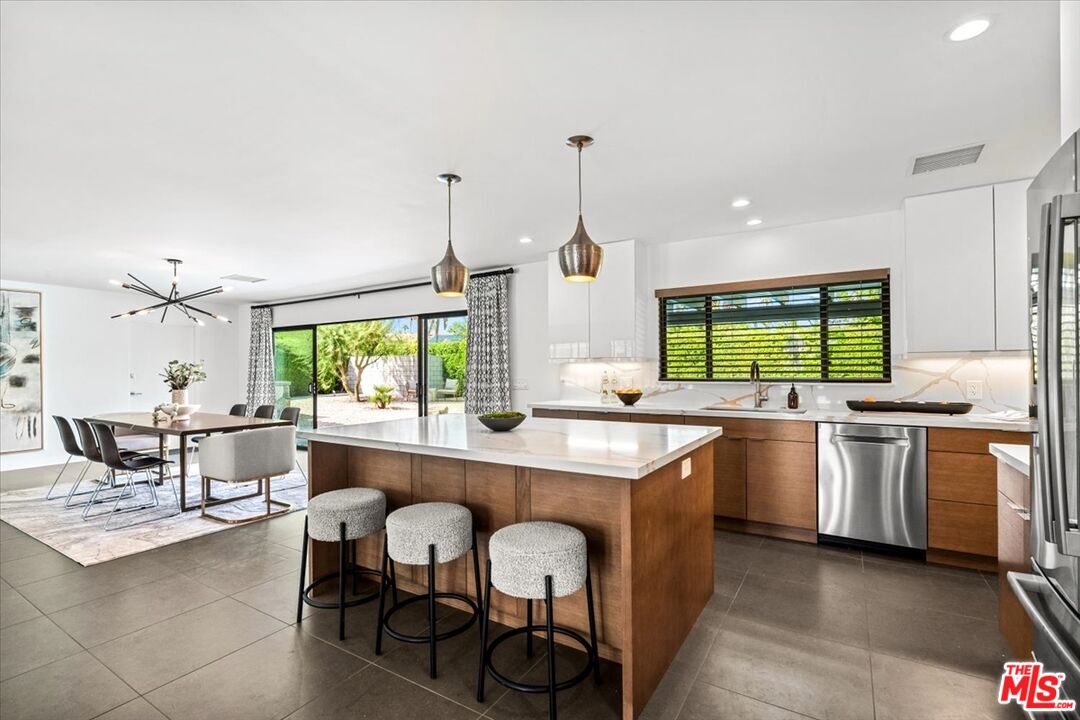 2994 Guadalupe Road Palm Springs, CA 92264 - Photo 12 of 33 a kitchen with lots of counter top space and dining table