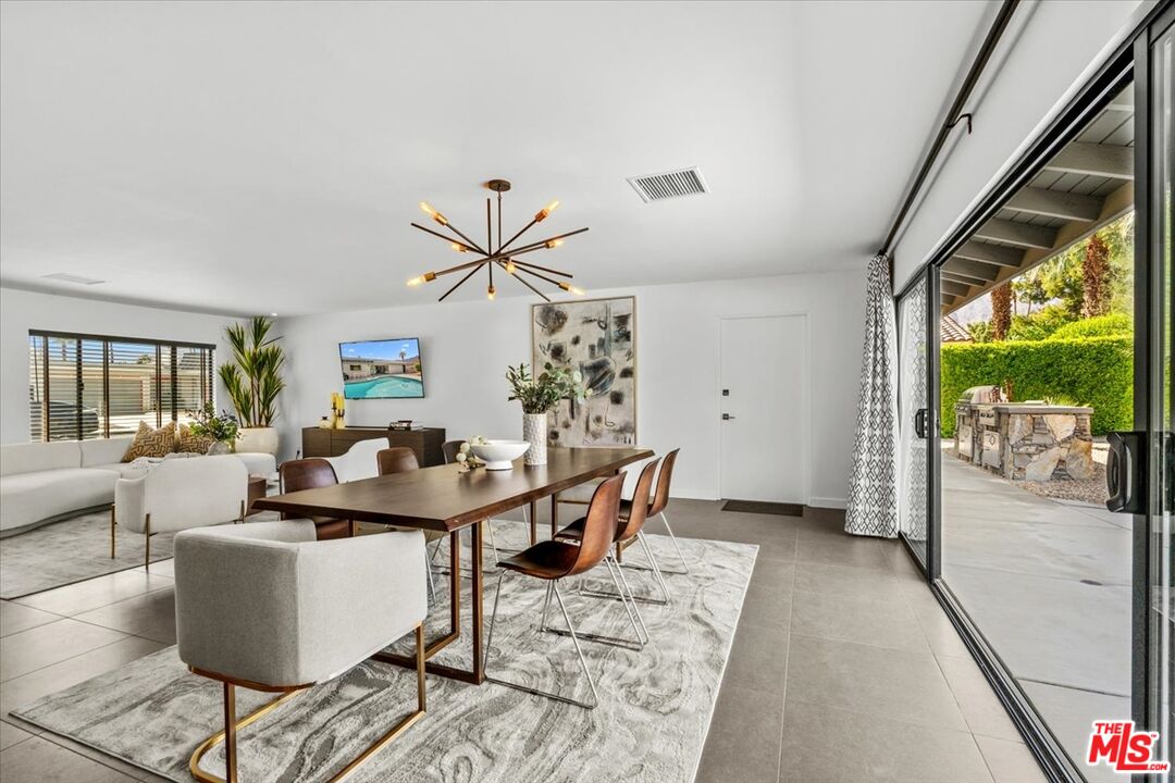 2994 Guadalupe Road Palm Springs, CA 92264 - Photo 13 of 33 a living room with couches a coffee table and a large window with outer view