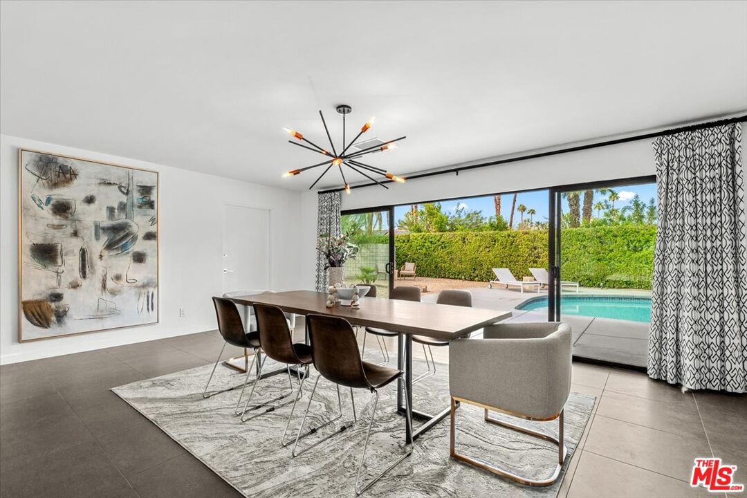 2994 Guadalupe Road Palm Springs, CA 92264 - Photo 14 of 33 a dining room with furniture window and wooden floor