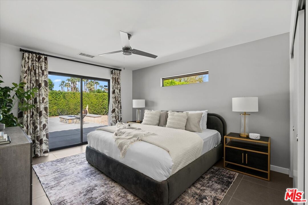 2994 Guadalupe Road Palm Springs, CA 92264 - Photo 17 of 33 a large bedroom with a bed and wooden floor