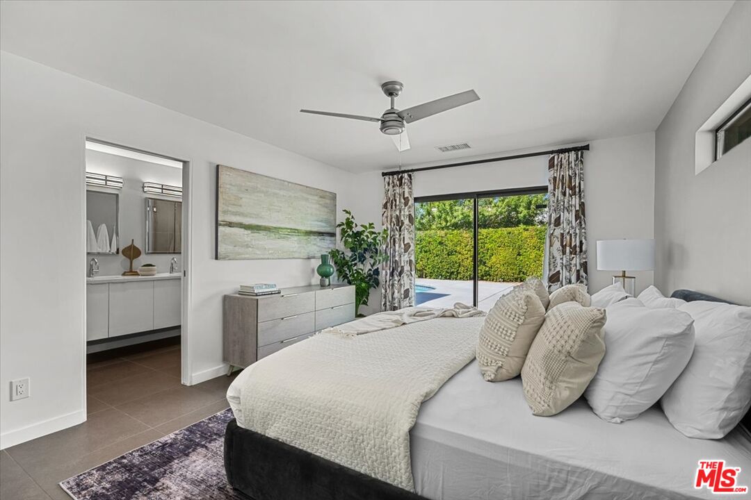 2994 Guadalupe Road Palm Springs, CA 92264 - Photo 18 of 33 a bedroom with a bed and a large window