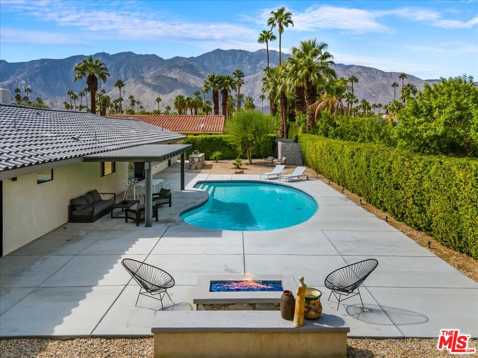 2994 Guadalupe Road Palm Springs, CA 92264 - Photo 29 of 33 a view of a patio with a table chairs and a swimming pool