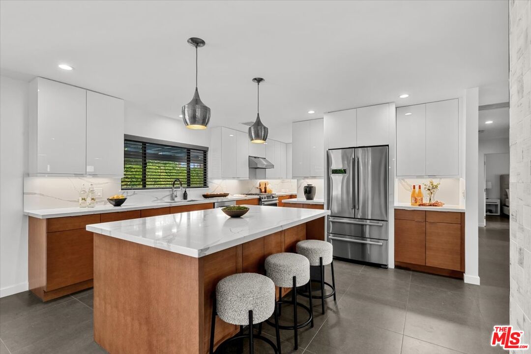 2994 Guadalupe Road Palm Springs, CA 92264 - Photo 8 of 33 a kitchen with refrigerator and chairs