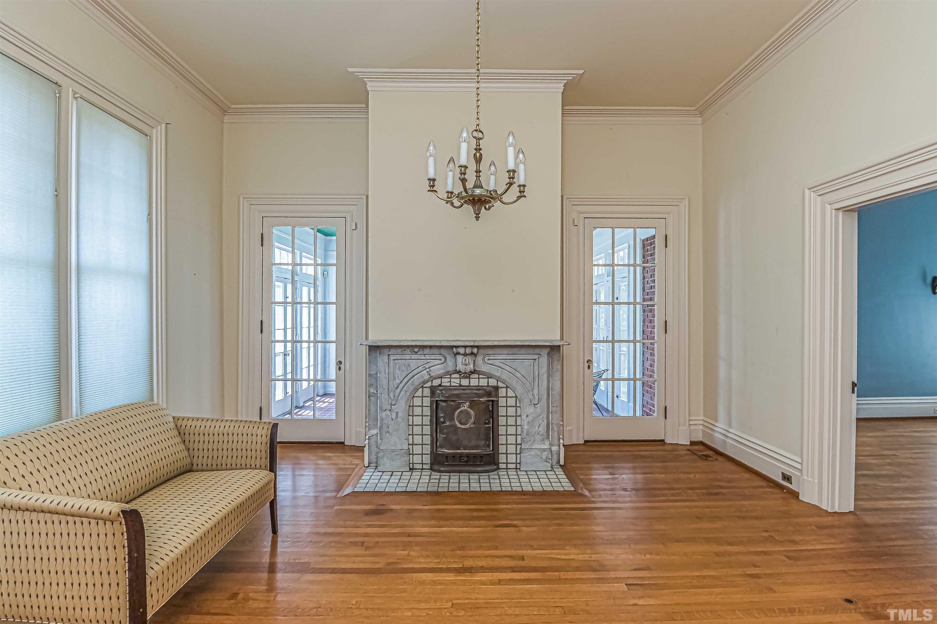 111 South George Street Goldsboro, NC 27530 - Photo 11 of 51 a living room with furniture a fireplace and a wooden floor