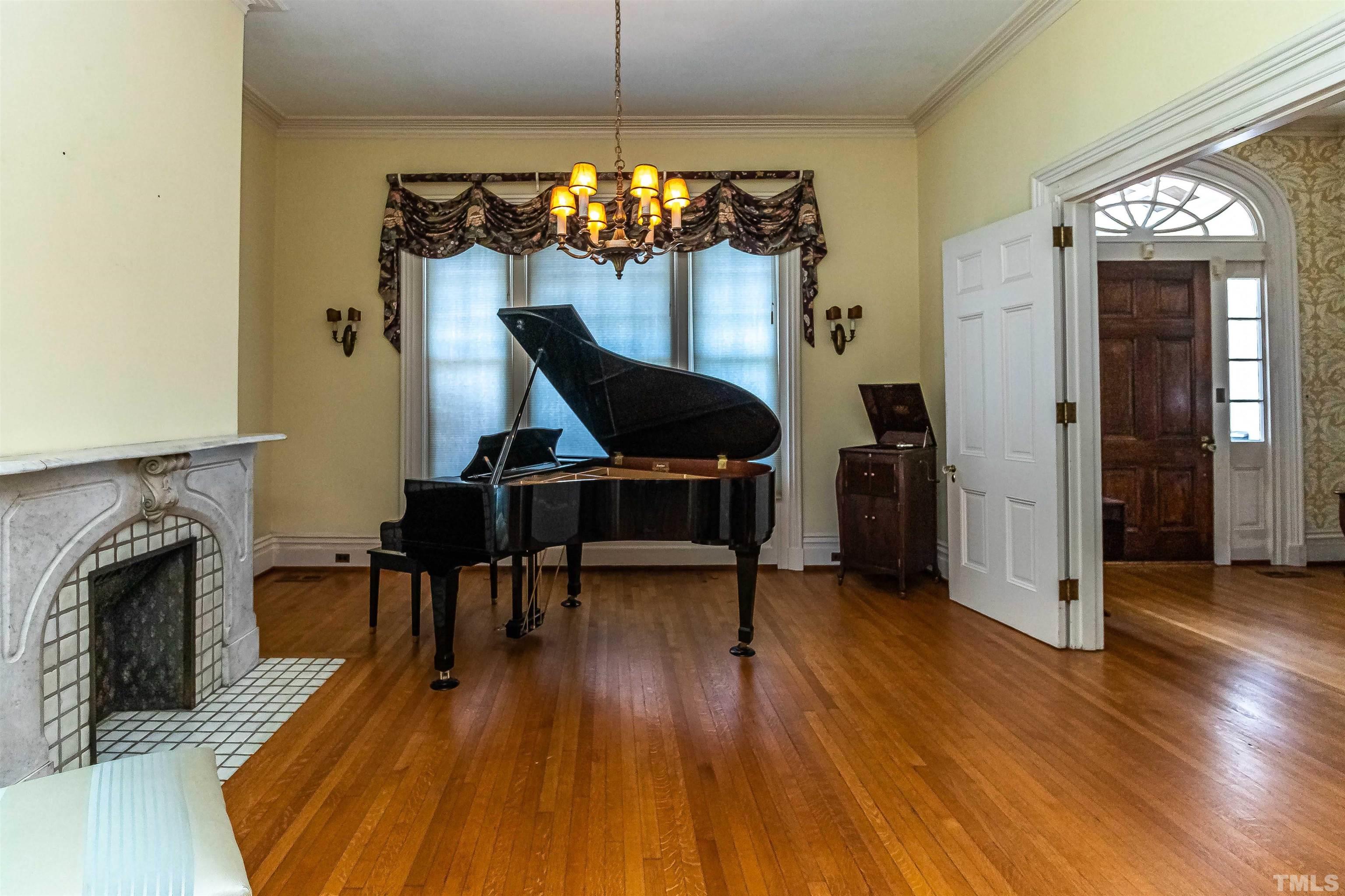 111 South George Street Goldsboro, NC 27530 - Photo 21 of 51 a view of a livingroom with furniture a fireplace and wooden floor