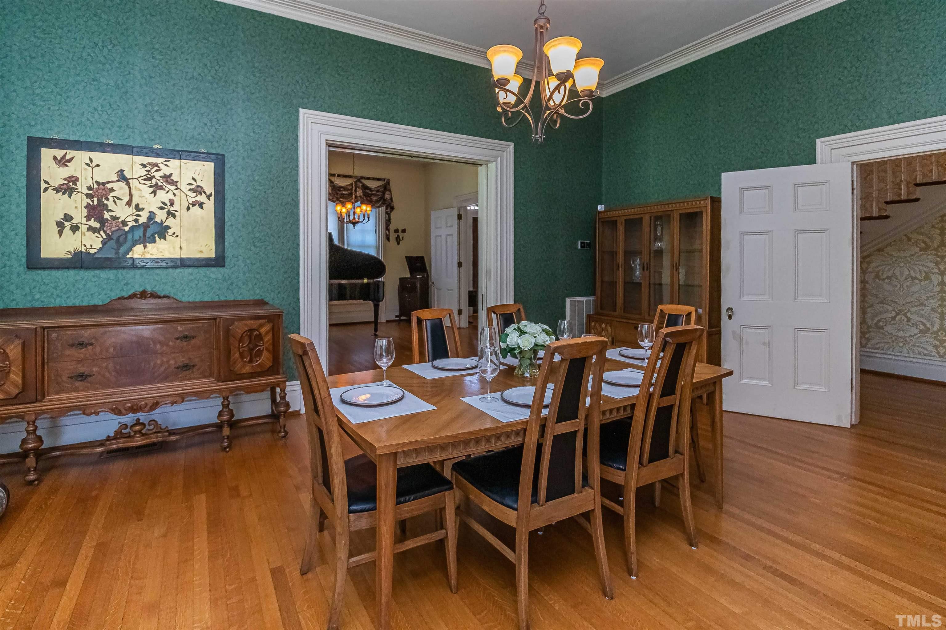 111 South George Street Goldsboro, NC 27530 - Photo 23 of 51 a view of a dining room with furniture wooden floor and chandelier