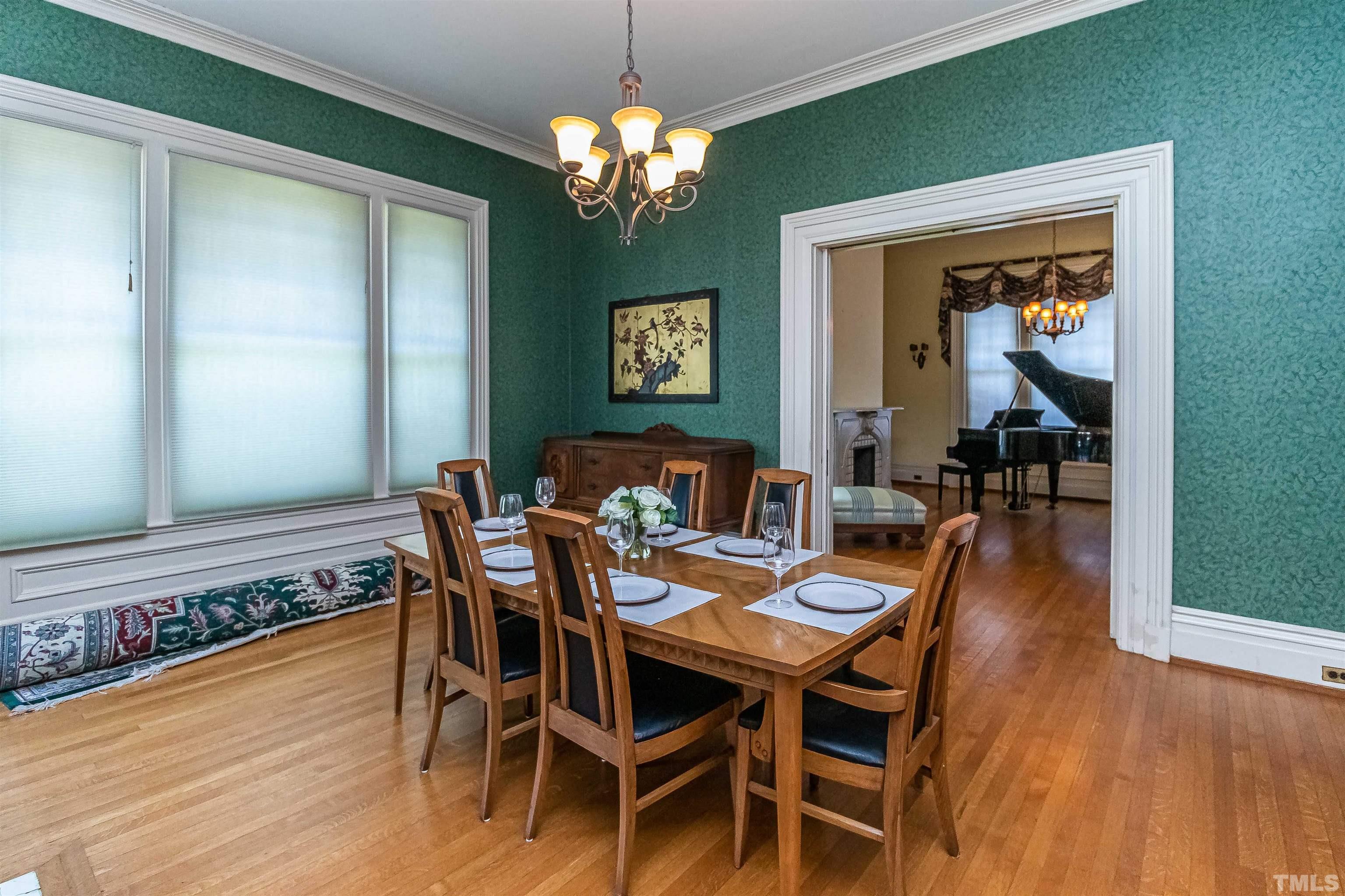 111 South George Street Goldsboro, NC 27530 - Photo 25 of 51 a view of a dining room with furniture wooden floor and chandelier