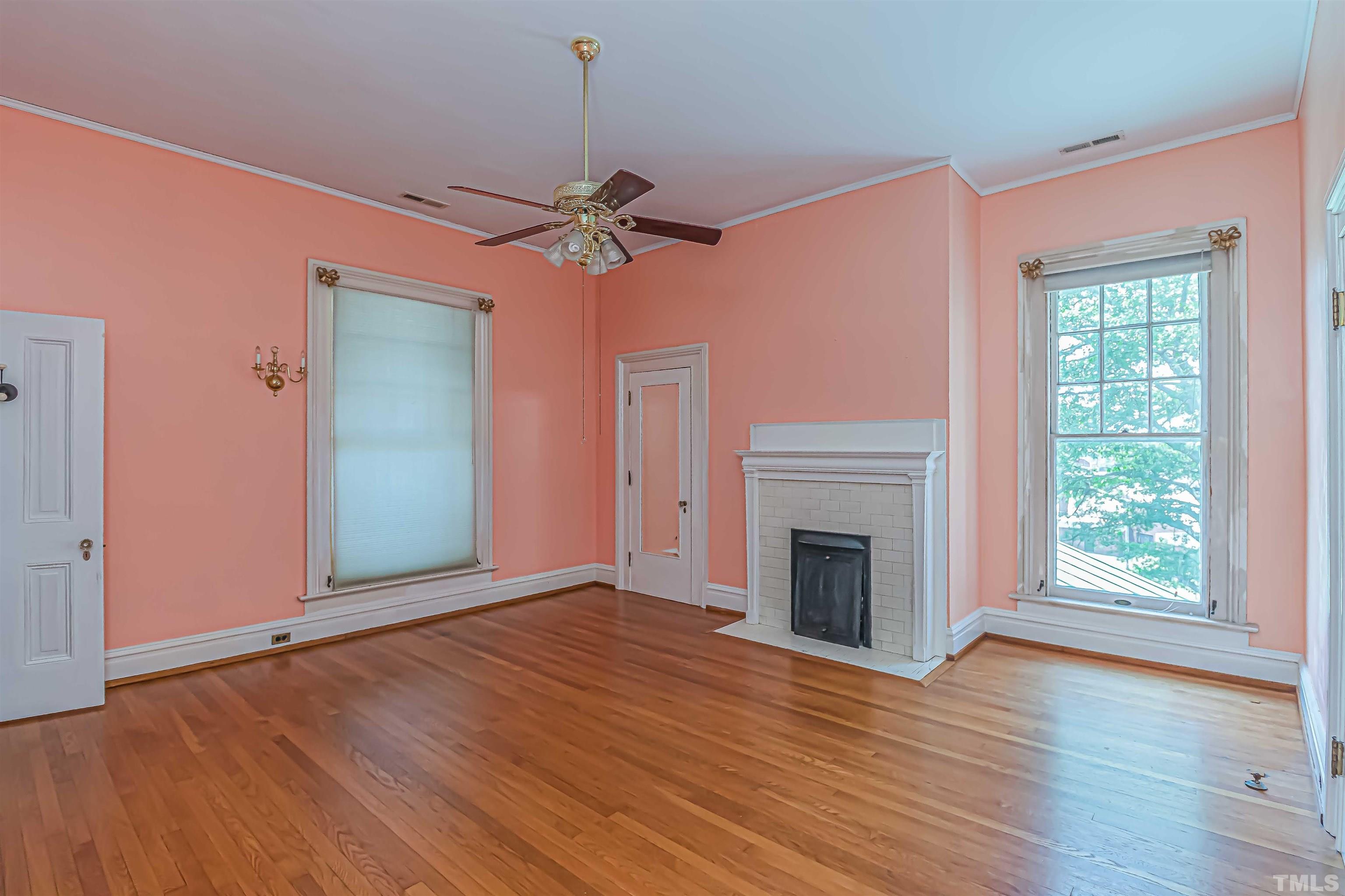 111 South George Street Goldsboro, NC 27530 - Photo 32 of 51 a view of empty room with wooden floor and fan