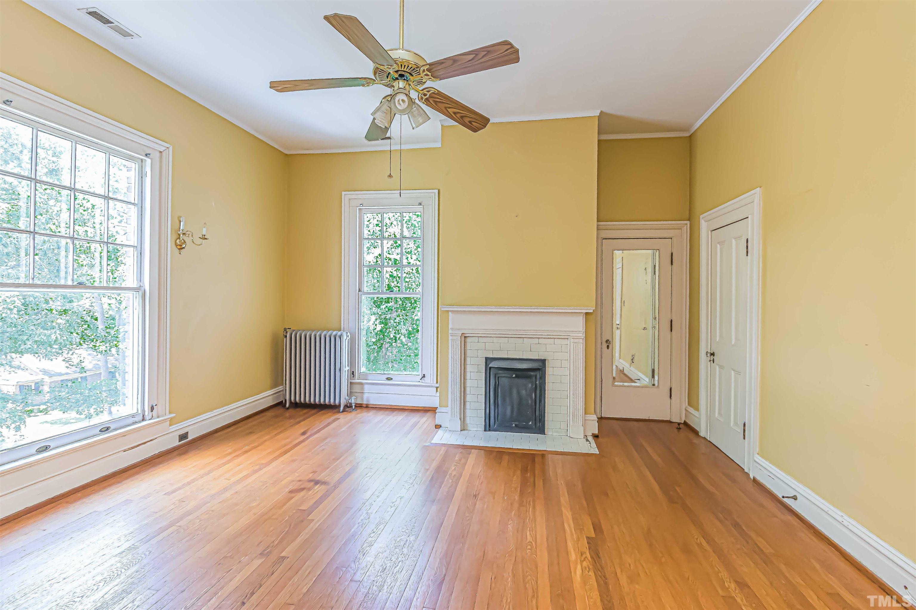 111 South George Street Goldsboro, NC 27530 - Photo 33 of 51 a view of empty room with wooden floor and fan