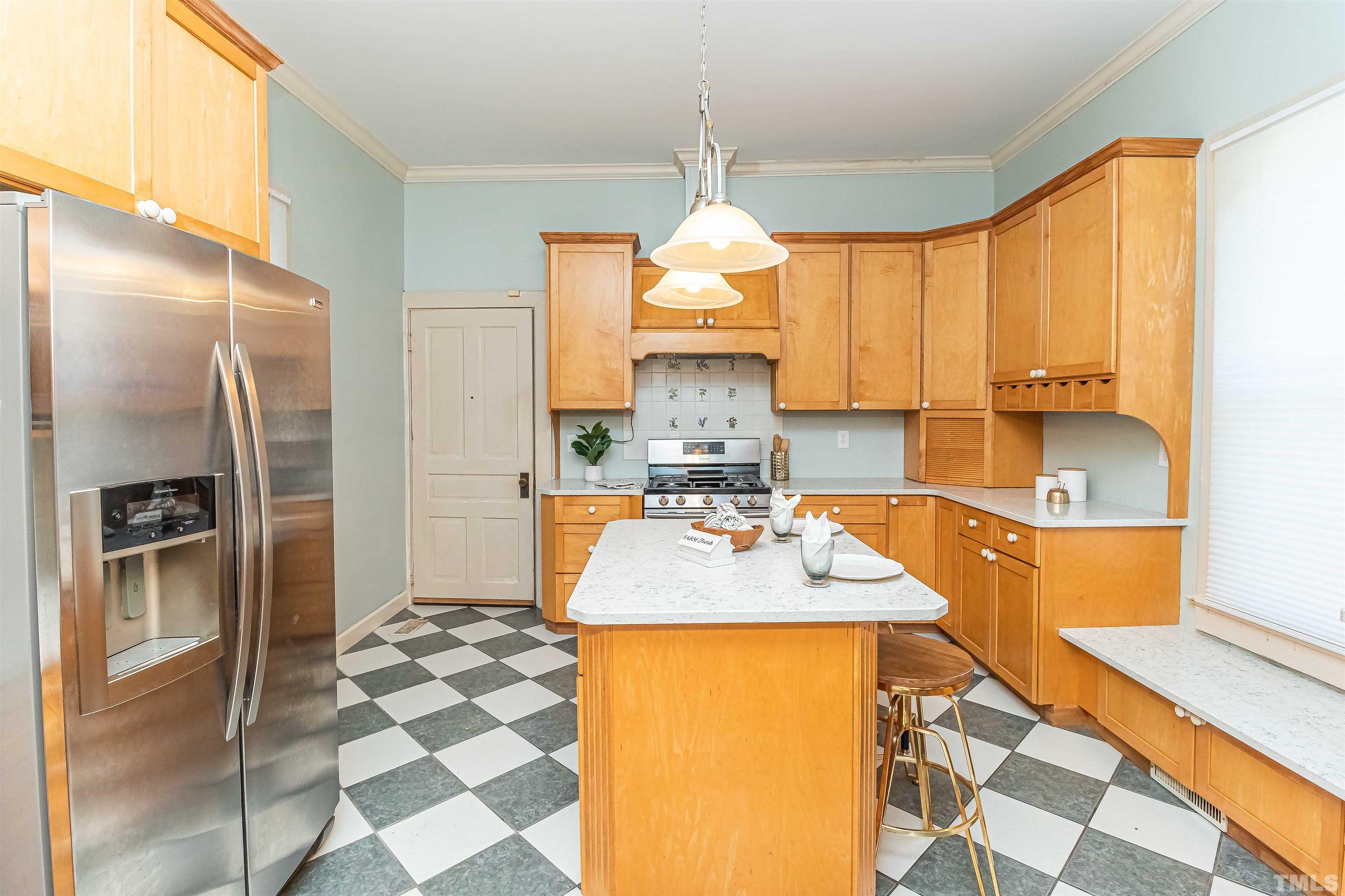 111 South George Street Goldsboro, NC 27530 - Photo 50 of 51 a kitchen with stainless steel appliances granite countertop a sink a refrigerator and a counter space