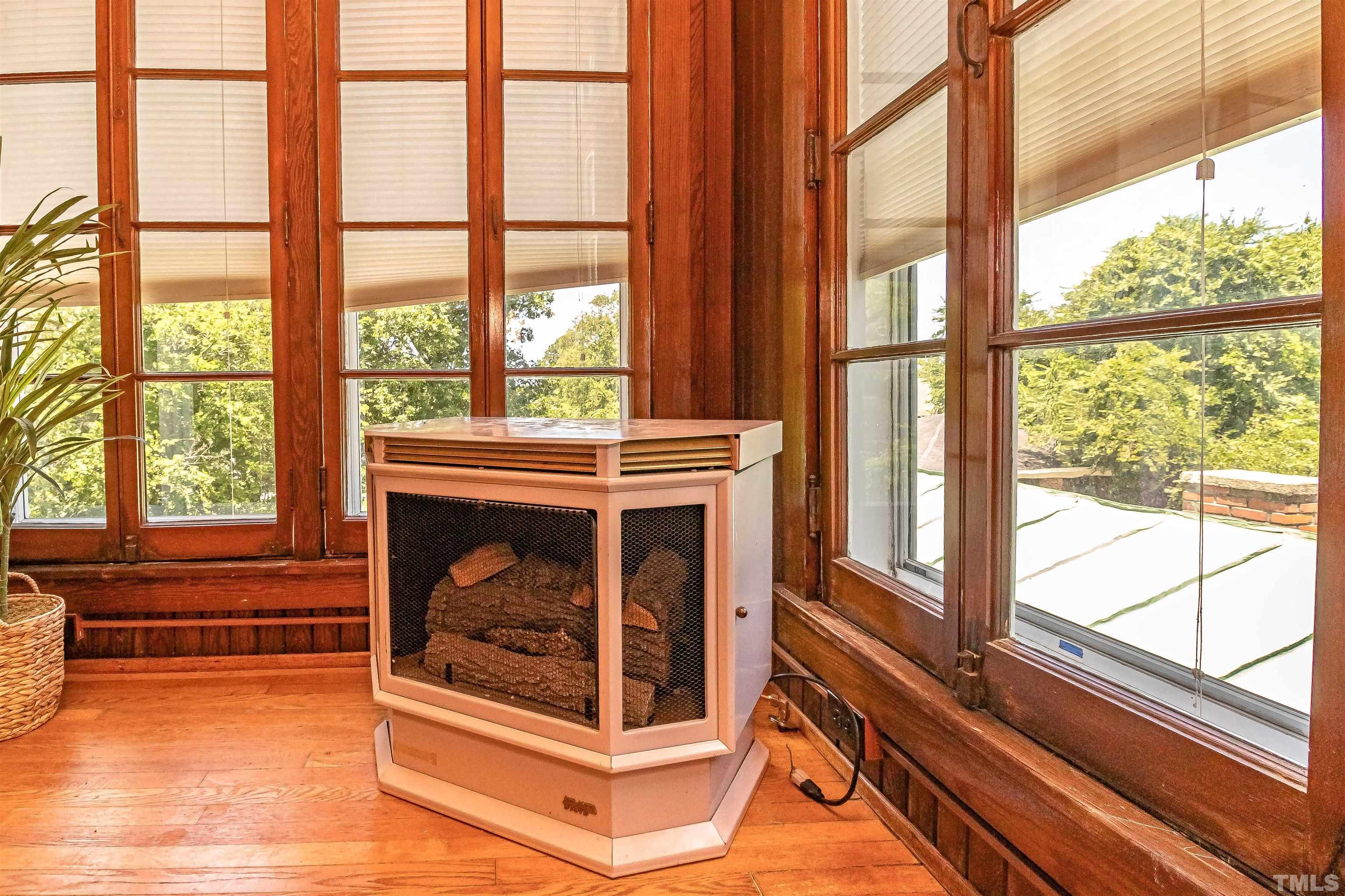 111 South George Street Goldsboro, NC 27530 - Photo 6 of 51 a living room with a fireplace and a large window with outer view